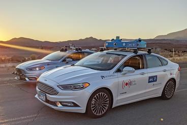 Two cars with VSI Labs automated vehicle technology parked in the desert